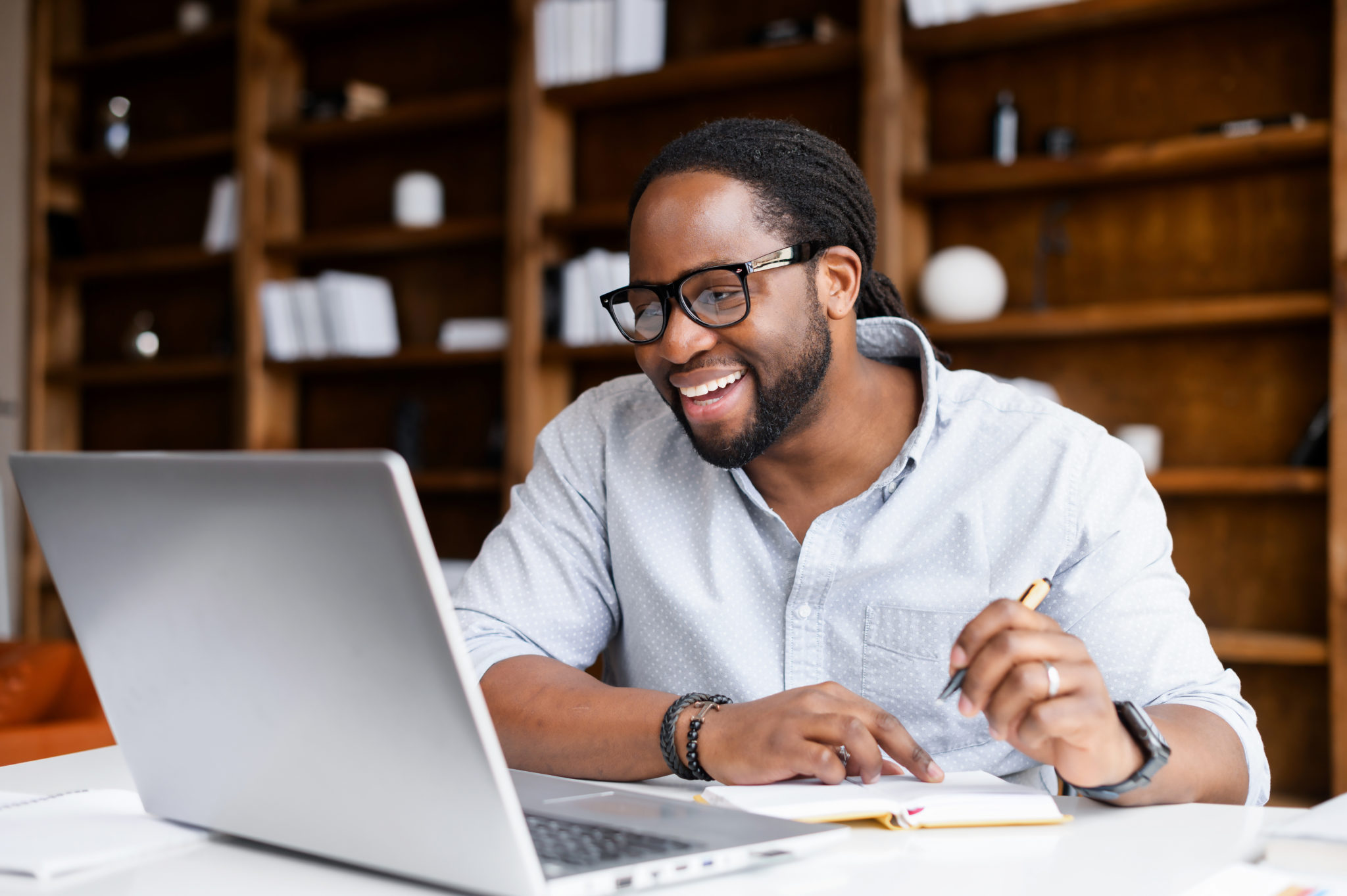 An African-American guy is using a laptop for studying | ITRAK 365